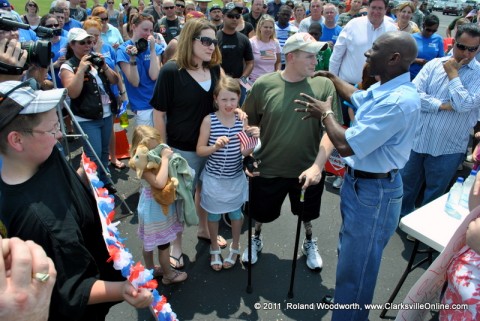 SSG Charles ( Chaz ) Allen with his wife Jessica and their two daughters Deryn and Ryann along with the crowd at Outlaw Field