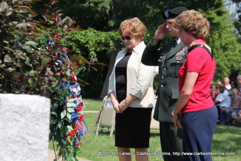 Montgomery County Mayor Carolyn Bowers, Col. William K. Gayler, and Clarksville Tennessee Mayor Kim McMillan pause for a moment of silence after placing a wreath in front of the War Memorial