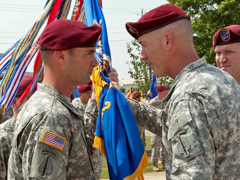 Command Sgt. Maj. Gregory Chambers (left) accepts the 160th Special Operations Aviation Regiment Colors from Col. John Thompson, commander of the 160th Special Operations Aviation Regiment (Airborne), as he assumed responsibility from Command Sgt. Maj. David Leamon during a ceremony at Fort Campbell, KY., on June 8th, 2011. (160th Special Operations Aviation Regiment courtesy photo.)