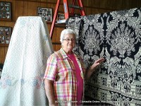 Helen Bellar showing off a woven coverlet