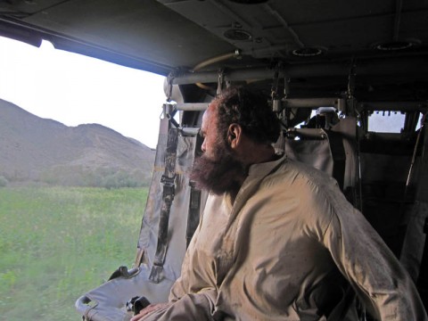 A local resident looks outside a UH-60 Black Hawk helicopter after being rescued from flood waters after multiple days of heavy rain. The man was among a group of 95 residents rescued by combined forces from Task Force Rakkasan and Afghan National Security Forces. Col Luong described this as one of his most enduring memories of his time with the 3rd Brigade Combat Team (Photo by: Staff Sgt. Sean Wright)