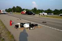 Honda motorcycle collided with the Tahoe, throwing the rider, and continued on without the rider to collided with a Nissan Versa. (Photo by CPD Jim Knoll)