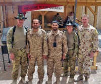 Pilots from Australian, United Arab Emirates and U.S. army aviation task forces pose for a group photo before a combined mission June 30th to destroy insurgent repeater towers in southern Afghanistan. This was the first time the three nations' aviators had worked together in an effort in support of Operation Enduring Freedom. (Photo by Spc. Mario Smith)