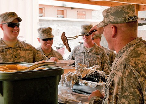 Soldiers from Company B, 1st Battalion, 506th Infantry Regiment, 4th Brigade Combat Team, 101st Airborne Division deployed to Combat Outpost Sar Howza, Paktika Province, Afghanistan, are served lunch by U.S. Army Lt. Col. David Preston, 801st Brigade Support Battalion commander, 4th Brigade Combat Team, 101st Airborne Division, Task Force Currahee, from Belchertown, MA, July 18th as a morale boost eight days after the loss of one of their own, Spc. Rafael Nieves. (Photo by U.S. Army Sgt. Charles Crail, Task Force Blackhawk Public Affairs)