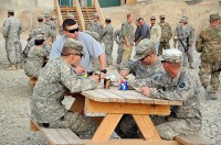 Task Force Currahee Soldiers from 4th Brigade Combat Team, 101st Airborne Division, mingle and enjoy a barbecue to celebrate Independence Day, July 4th, at Forward Operating Base Sharana in Paktika Province, Afghanistan. (Photo by U.S. Army Spc. Kimberly K. Menzies, Task Force Currahee Public Affairs)