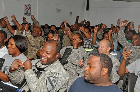 Chief Warrant Officer 4 Keith Anderson of the 101st Sustainment Brigade Support Operations, shares his words during “Poetry Night” at the Morale, Welfare and Recreation Center at Bagram Airfield, Afghanistan. The event offers service members a creative outlet for relaxation while deployed in a combat environment. (Photo by Sgt. 1st Class Peter Mayes)