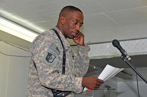 Chief Warrant Officer 4 Keith Anderson of the 101st Sustainment Brigade Support Operations, shares his words to an appreciative crowd during “Poetry Night” at the Morale, Welfare and Recreation Center at Bagram Airfield, Afghanistan. The event offers service members a creative outlet for relaxation while deployed in a combat environment. (Photo by Sgt. 1st Class Peter Mayes)