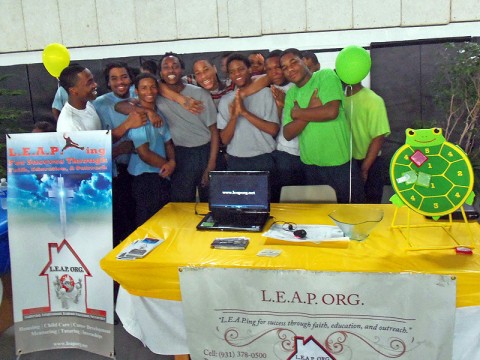 Some of the youth from the Woodland Hills Youth Development Center stand behind the LEAP Organization booth at the Woodland Hills Career Fair (Photo by Richard Garrett)