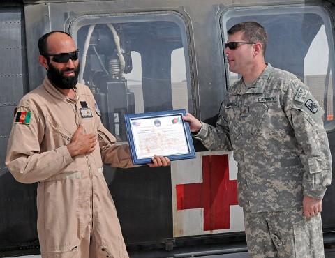 Afghan Air Force flight medic Sgt. Gulap Ahmadzia receives a certificate of completion, July 27th, from Company C, 1st Battalion, 52nd Aviation Regiment company commander Maj. Michael Mendenhall, for completion of the U.S. Army and Afghanistan Air Force medical evacuation partnership program here. Ahmadzia is the first Afghan flight medic to join Task Force Thunder's medevac crews as they move patients off of the battlefield. (Photo by Sgt. Shanika Futrell) Afghan Air Force flight medic Sgt. Gulap Ahmadzia receives a certificate of completion, July 27th, from Company C, 1st Battalion, 52nd Aviation Regiment company commander Maj. Michael Mendenhall, for completion of the U.S. Army and Afghanistan Air Force medical evacuation partnership program here. Ahmadzia is the first Afghan flight medic to join Task Force Thunder's medevac crews as they move patients off of the battlefield. (Photo by Sgt. Shanika Futrell)
