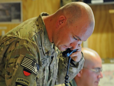 Staff Sgt. Joshua DeWitt, the fire support officer for Task Force Wings, calls to establish a restricted operating zone as he verifies grid coordinates for support from a mortar team at Forward Operating Base Wolverine July 27th. (Photo by Sgt. 1st Class Stephanie Carl)