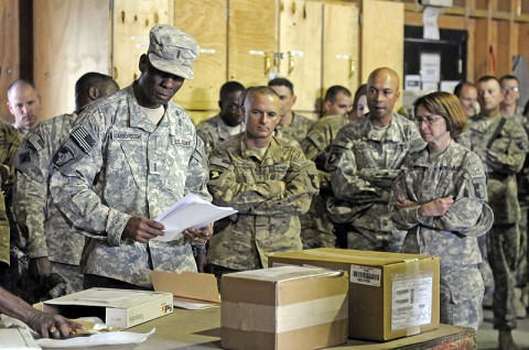 Chief Warrant Officer 4 Jerry Scarborough, of support operations, 101st Sustainment Brigade, shows leaders of the 101st Sust. Bde. the process of receiving goods at the Bagram Supply Support Agency. (Photo by Spc. Michael Vanpool)