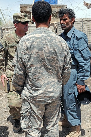 Capt. Mark A. Herlick (left), Pathfinder Company commander, discusses logistics needs with a member of the Surri District Afghan National Police following a shura July 28th. (Photo by Sgt. Shanika Futrell) Capt. Mark A. Herlick (left), Pathfinder Company commander, discusses logistics needs with a member of the Surri District Afghan National Police following a shura July 28th. (Photo by Sgt. Shanika Futrell)