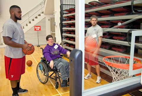 APSU students Ashlon Adams (left) and Brian Bourland play basketball with Dee during an adapted physical education class September 23rd in the Dunn Center. (Photo by Beth Liggett, APSU photographer)