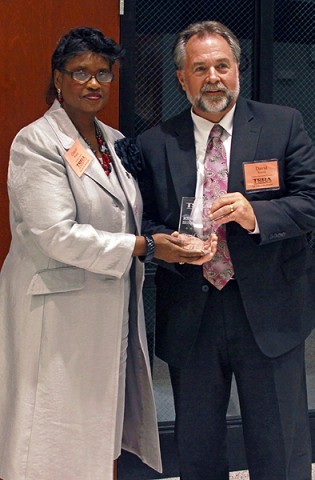 David Smith is presented the award by Mid Cumberland District Director and Metropolitan Nashville School Board Chair Gracie Porter.