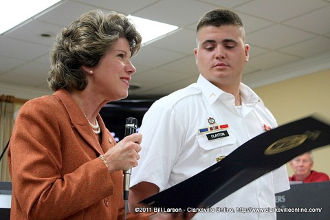 Clarksville Mayor Kim McMillan reads the narrative of the award as PFC Preston Clayton looks on