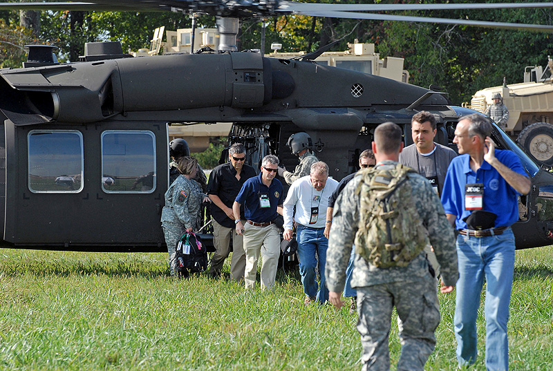 Civilians participating in the Joint Civilian Orientation Conference sponsored by the Secretary of Defense exit a UH-60 Black Hawk during their visit to Fort Campbell, September 22nd. The select group of participants gained insight on what a 101st Airborne Division soldier does on a routine basis. (Photo by Sgt. Scott Davis)