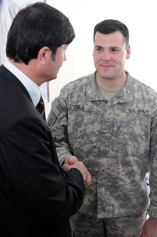 Maj. Jason Cole, the tactical command post officer in charge, 101st Sustainment Brigade Joint Combat Outpost Hairatan, talks with the port director of Hairatan. (Photo by Spc. Michael Vanpool)