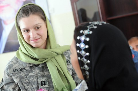 Capt. Kristin Strobel, Commander’s Emergency Response Program officer for the 101st Sustainment Brigade “Lifeliners,” Joint Combat Outpost Hairatan, talks with one of the female workers of the day at the port of Hairatan following a ceremony. The team of Lifeliners at Hairatan donated cribs, desks and school supplies to the day care which supports the employees of the port and railroad. (Photo by Spc. Michael Vanpool)