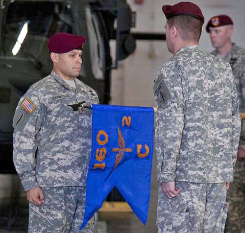 Maj. Keith Sandoval (left), commander of C Company 2nd Battalion, 160th Special Operations Aviation Regiment (Airborne), and Lt. Col. Phil Ryan, commander of 2nd Battalion 160th SOAR (A), watch as the company colors are unfurled for the first time during an activation ceremony at Fort Campbell, KY., Sept. 12th, 2011. (160th Special Operations Aviation Regiment courtesy photo)