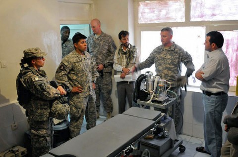 Maj. Deidre Lockhart, medical operations officer for the 101st Sustainment Brigade, and Col. Michael Peterman, brigade commander, 101st Sus. Bde., Sayed Padshahy, a local contractor, and Dr. Khaleque, the hospital administrator, stand in the sole operating room at the Dehdadi District Public Hospital, September 6th. (Photo by Spc. Michael Vanpool)