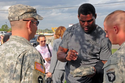 Herschel Walker, former NFL star and mixed martial arts fighter, autographs personal effects of Soldiers with 1st Battalion, 320th Field Artillery Regiment, 2nd Brigade Combat Team, 101st Airborne Division (Air Assault), at the battalion’s headquarters at Fort Campbell, KY, Sept. 28th. Walker spoke to the Soldiers about his experience and benefits in seeking mental health care. (U.S. Army Photo By Spc. Shawn Denham, PAO, 2nd BCT, 101st Abn. Div.)