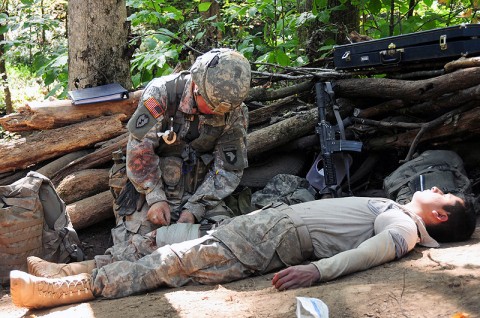 Sgt. Matthew Baumann, with Headquarters and Headquarters Company, 1st Battalion, 502nd Infantry Regiment, 2nd Brigade Combat Team, 101st Airborne Division (Air Assault), treats a simulated casualty during testing for the Expert Field Medical Badge at Fort Campbell, October 5th. Baumann and 11 other Soldiers from Strike Brigade received their EFMB’s the next day. (U.S. Army Photo By Spc. Shawn Denham, PAO, 2nd BCT, 101st Abn. Div.)