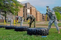 Staff officers with Headquarters and Headquarters Company, 2nd Brigade Special Troops Battalion, 2nd Brigade Combat Team, 101st Airborne Division (Air Assault), hit tires with sledgehammers during the Iron Strike Challenge, at Fort Campbell, KY, Oct. 20th. Soldiers compete monthly to win a brigade challenge coin, certificate of achievement and four-day pass. (U.S. Army Photo By Spc. Shawn Denham, PAO, 2nd BCT, 101st Abn. Div.)