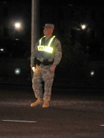 Spc. Ryan P. Carroll, a patrolman with Headquarters and Headquarters Company, 1st Special Troops Battalion, 1st Brigade Combat Team, controls traffic at his Traffic Control Point, October 17th, at the intersection of Indiana Avenue and Bastogne Street. (Photo by Sgt. Jon Heinrich)