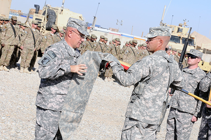 Command Sgt. Maj. John Seelhorst, command sergeant major of the 129th Combat Sustainment Support Battalion, and Lt. Col. Daniel Rickleff, the commander of the 129th, case their battalion colors as a transfer of authority ceremony at Camp Leatherneck, Helmand province, October 12th. The battalion staff was deployed to Regional Command Southwest, where they took over command and control of companies from active and reserves and Alaska to Germany. (Photo by Spc. Michael Vanpool)