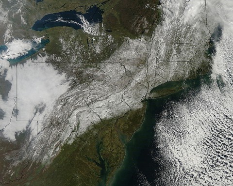 This visible image from the MODIS instrument on NASA's Aqua satellite on October 30th, 2011 at 11:30am EDT shows the extent of snowfall from the Halloween weekend Nor'easter that spread snow from West Virginia to Maine along the U.S. East coast. The snow is seen blanketing the ground, while clouds remain off-shore over the Atlantic Ocean. (Credit: NASA Goddard MODIS Rapid Response Team)