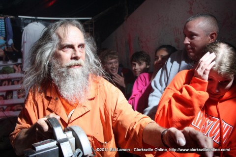 An actor entertains a group of thrill seekers in the 2011 Bikers Who Scare Haunted House