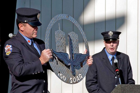 New York City Fire Department personnel Patrick Neville (left) and Justin Devine (right) present Regiment with a plaque recognizing Night Stalker contributions over a decade of deployments supporting the War on Terror during the unit’s 30th Anniversary Celebration October 15th, 2011. Neville crafted the plaque using a piece of steel recovered from one of the World Trade Center towers and metal from a fire truck at ground zero to the Regiment. (160th Special Operations Aviation Regiment photo)