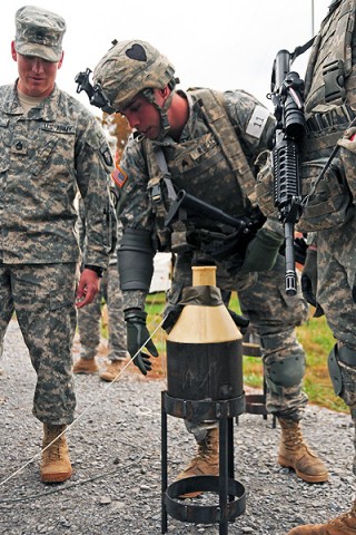 Sgt. Justin Roesch, a squad leader and combat engineer with Company A, 2nd Brigade Special Troops Battalion, 2nd Brigade Combat Team, 101st Airborne Division (Air Assault), inspects a road demolition charge during ‘Sapper Stakes’ at Fort Campbell, KY, Oct. 26th. (U.S. Army Photo By Spc. Shawn Denham, PAO, 2nd BCT, 101st Abn. Div.)