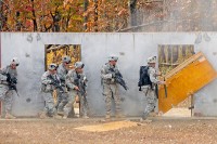 Smoke from a door-breaching explosive clears as combat engineers with Company A, 2nd Brigade Special Troops Battalion, 2nd Brigade Combat Team, 101st Airborne Division (Air Assault), move in to ‘clear’ a simulated building during ‘Sapper Stakes’ at Fort Campbell, KY, Oct. 26th. Door breaching is a common practice among sappers and used commonly during urban missions. (U.S. Army Photo By Spc. Shawn Denham, PAO, 2nd BCT, 101st Abn. Div.)