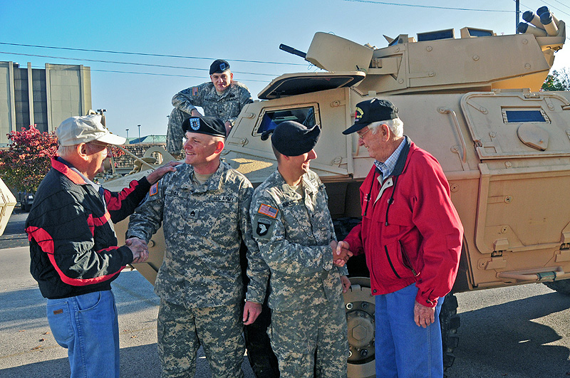 Staff Sgt. Christopher Bill and Spc. Charles Simko, both with Strike’s military police from Headquarters and Headquarters Company, 2nd Brigade Special Troops Battalion, 2nd Brigade Combat Team, 101st Airborne Division (Air Assault), shake the hands of World War II Veterans James Chadwell and John Mason next to an M1117 Armored Security Vehicle at Hopkinsville’s Veteran’s Day Parade, Nov. 5th. Veterans from World War II, Korea, Vietnam, the Middle East and Afghanistan took part in the town’s day of honor. (U.S. Army photo by Sgt. Joe Padula, 2nd BCT PAO, 101st Abn. Div.)