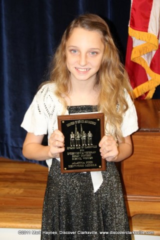 Alayna Pike receives an award at the Clarksville Kiwanis Club's Memories of Service and Sacrifice Project's "Interview a Veteran" essay contest.