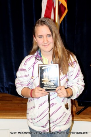 Arianna Reiley receives an award at the Clarksville Kiwanis Club's Memories of Service and Sacrifice Project's "Interview a Veteran" essay contest.