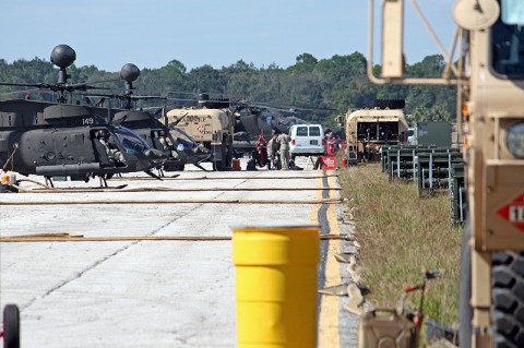 Soldiers of the 101st Combat Aviation Brigade work diligently to fuel the OH-58D Kiowa Warrior helicopter during daylight training operations at Avon Park, Fla., Oct. 23, 2011 during Jaded Thunder, where they set up and ran their own forward arming and refueling point. (US Army photo by Staff Sgt. Andrew McClure)