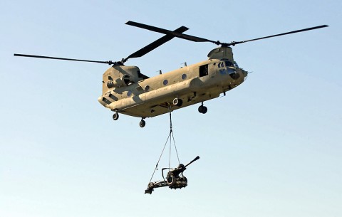 A CH-47 Chinook helicopter airlifts a M119 Howitzer as part of the mission objective for Battery A, 2nd Battalion, 320th Field Artillery, 1st Brigade Combat Team during their air assault raid Nov. 17th here. (Photo by Sgt. Jon Heinrich)