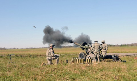 Section 1, Battery A, 2nd Battalion, 320th Field Artillery, 1st Brigade Combat Team, fires a 105 mm high explosive round from their M119 Howitzer Nov. 17th during their battery air assault raid here. (Photo by Sgt. Jon Heinrich)