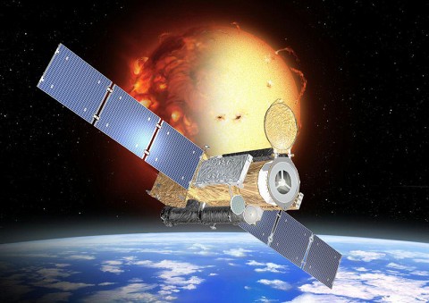 Artist's concept of the Hinode spacecraft in orbit around the Earth with an active sun in the background. (Credit: JAXA)