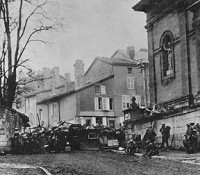 Soldiers of the 353rd Infantry near a church at Stenay, Meuse in France, wait for the end of hostilities.  This photo was taken at 10:58am, on November 11th, 1918, two minutes before the armistice ending World War I went into effect.