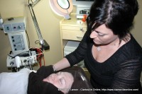 Author Sue Culverhouse receiving her facial from Miller-Motte Technical College student Renee Drake