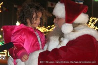 Santa Claus talks with a young lady about her Christmas wishes