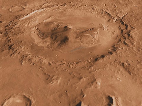 This oblique, southward-looking view of Gale crater shows the mound of layered rocks that NASA's Mars Science Laboratory will investigate. The mission's selected landing site is just north of the mound inside the crater. (Image Credit: NASA/JPL-Caltech/ASU/UA)