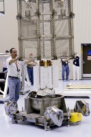 A technician oversees the removal of a ventilated cage over the MMRTG that will be used to generate electricity for the MSL on Mars. (Photo credit: NASA/Troy Cryder)