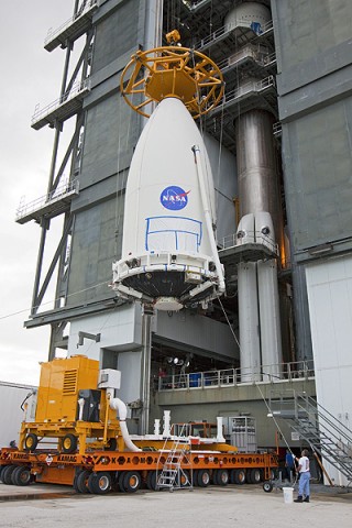 The Mars Science Laboratory, bolted inside the payload fairing of an Atlas V rocket, is hoisted into place at Launch Complex 41 at Cape Canaveral Air Force Station in Florida. (Photo credit: NASA/Kim Shifletta)