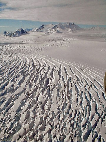 The frozen, inhospitable surface features of Alexander Island in Antarctica were viewed at close range during one of the final low-level flights by NASA's DC-8 flying laboratory during the 2011 Antarctic IceBridge mission. (NASA /Chris Miller)