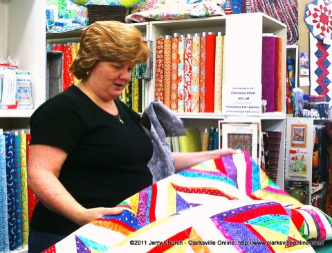 A customer at the Quilt and Sew at Golden Threads looking at a quilt