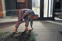 Spc. Martin Gregory, a fire control specialist with Battery A, 2nd Battalion, 320th Field Artillery Regiment, 1st Brigade Combat Team, 101st Airborne Division, picks up a cigarette butt while patrolling the area around the barracks while on charge of quarters November 10th. (Photo by Sgt. Richard Daniels Jr.)